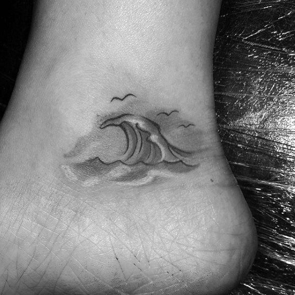 Shaded Black And Grey Ink Small Ocean Wave Ankle Tattoo Designs On Gentleman