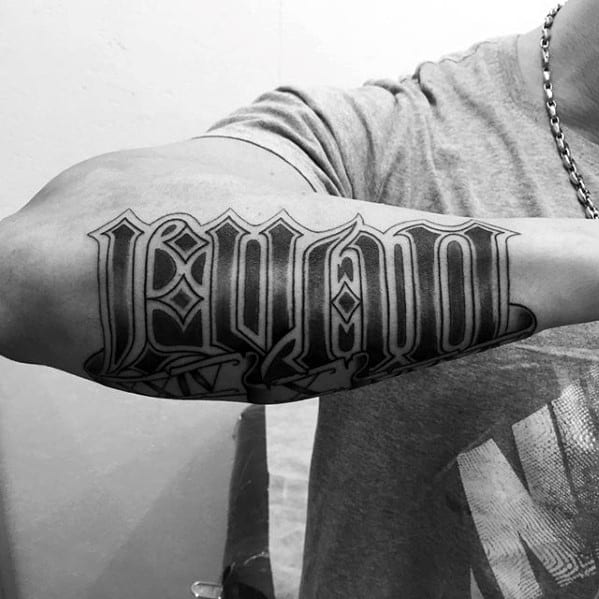 Shaded Black Ink Outer Forearm Name Tattoo On Man