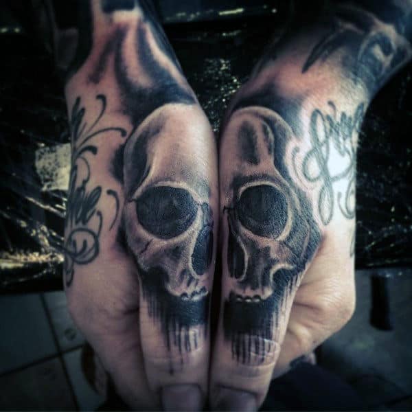 Shaded Skull Thumb Tattoo On Man With Black And Grey Ink
