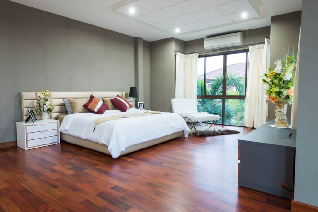 large gray bedroom hardwood floor white ottoman 