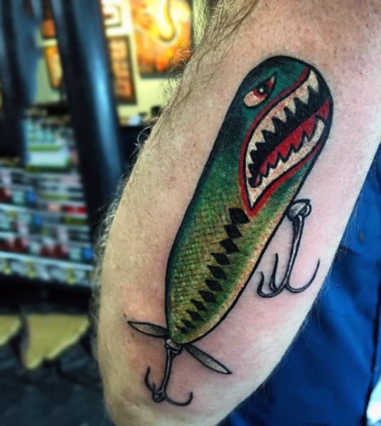 Shark Themed Fish Hook With Green Red And White Ink On Mans Outer Forearm
