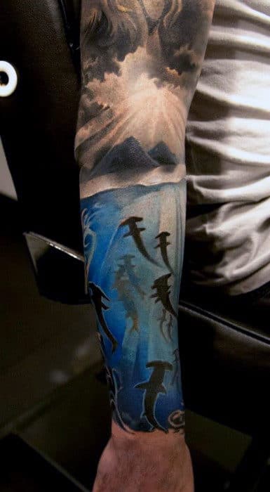 Sharks Swimming Towards Sunray Clouds Mens Sleeve Tattoo