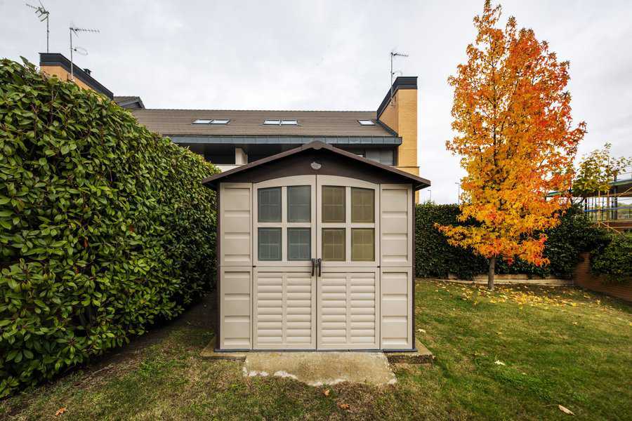 small backyard shed with balcony
