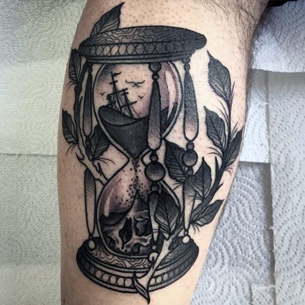 Ship And Skull Inside Of Hourglass Tattoo For Men On Back Of Leg Calf