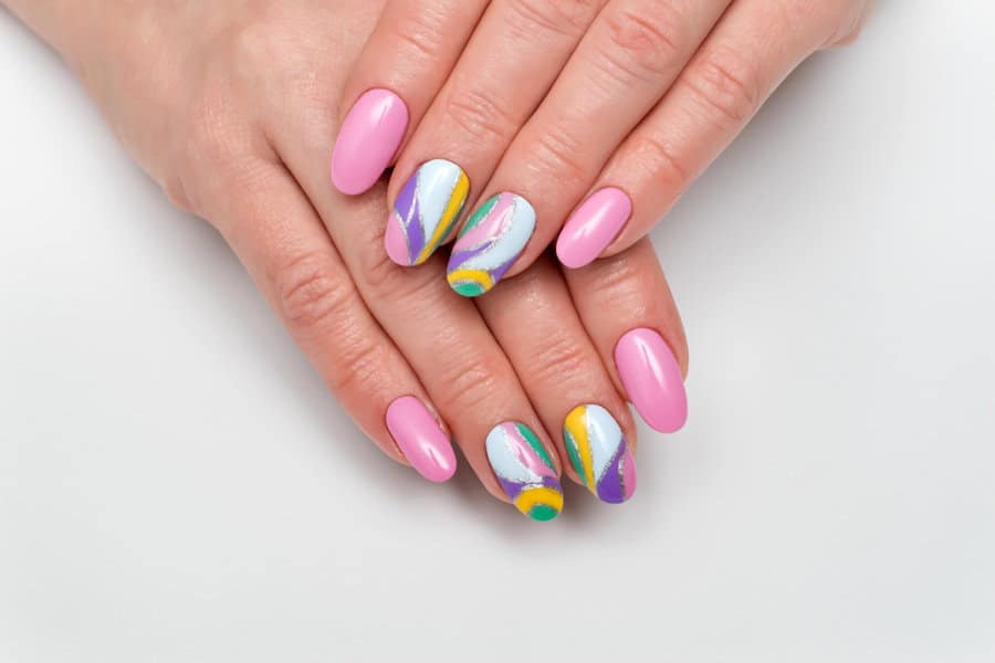 Pink nails with colorful swirl accents