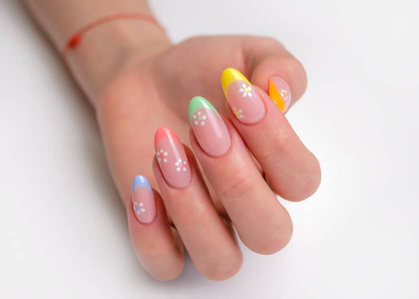 Colorful French manicure with daisies