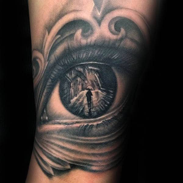 Silhouette Of Person Inside Eye Guys Arm Tattoo
