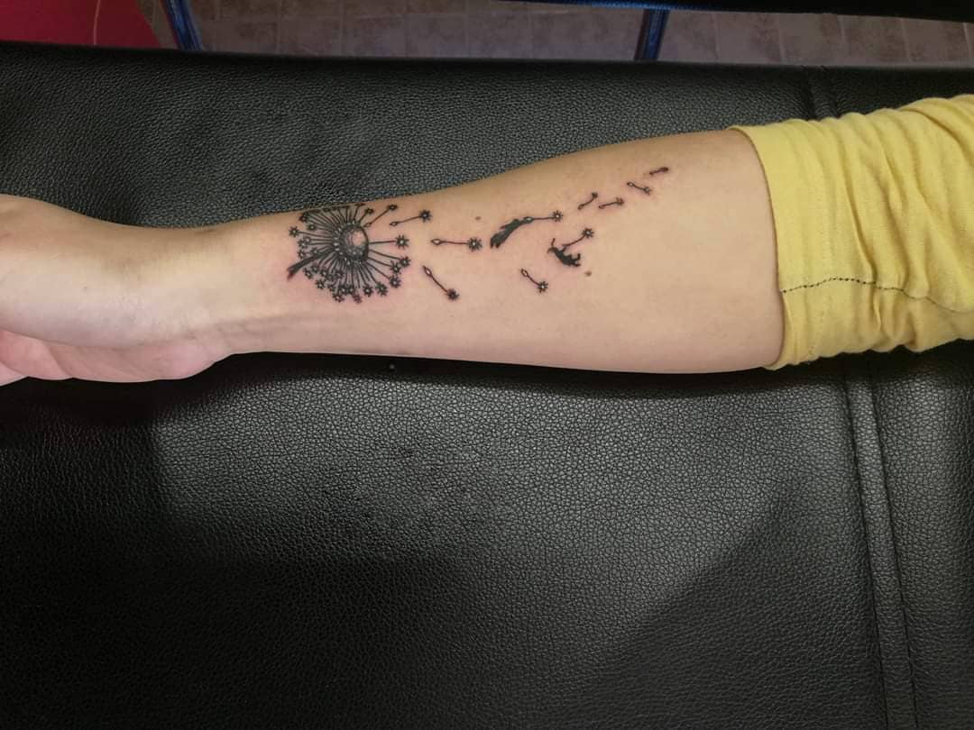 simple arm dandelion tattoo