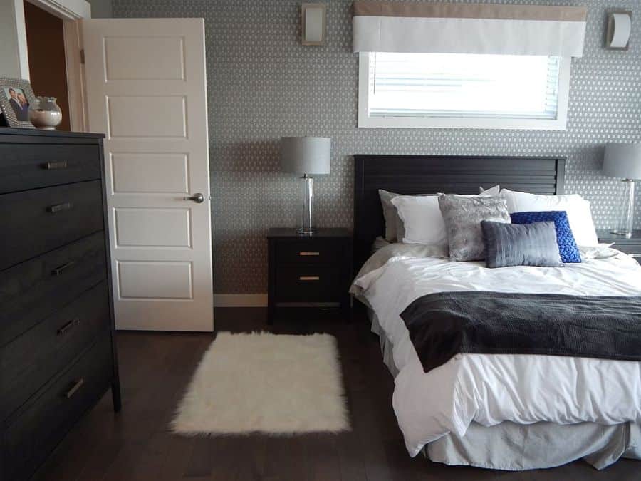 simple contemporary bedroom white floor rug floorboards white door
