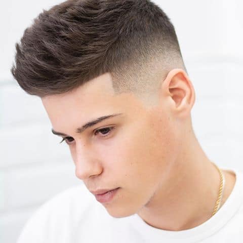 A modest burst fade with barely noticeable hair fading transition on the sides and back