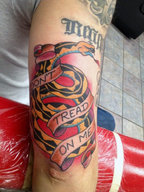 Simple Color Dont Tread On Me Text And Snake Tattoo For Men Upperarm