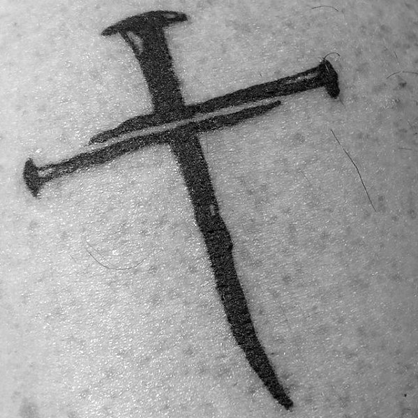 simple-cross-nails-mens-chest-tattoo