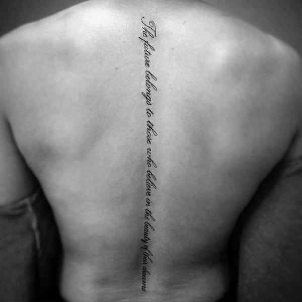 Simple Cursive Lettering Quote Spine Tattoo On Man