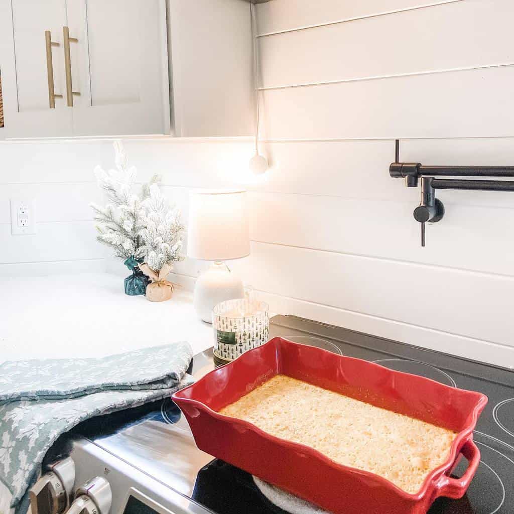 white shiplap walls stove red cooking tray