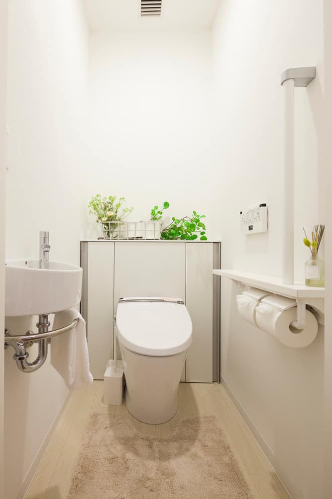 white powder room with sink and toilet 