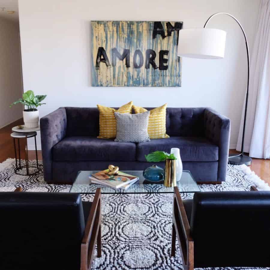 purple sofa and glass coffee table mid-century living room 