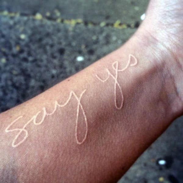 Simple Say Yes White Ink Lettering Tattoo For Men On Wrist