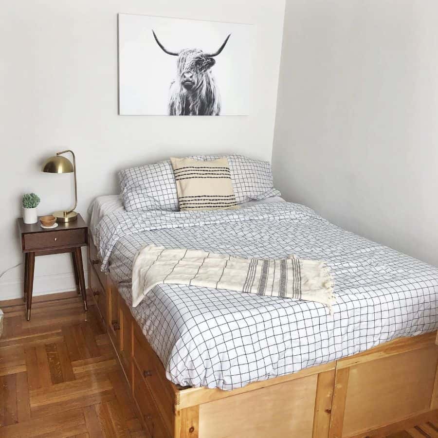 simple small bedroom with bison canvas painting 