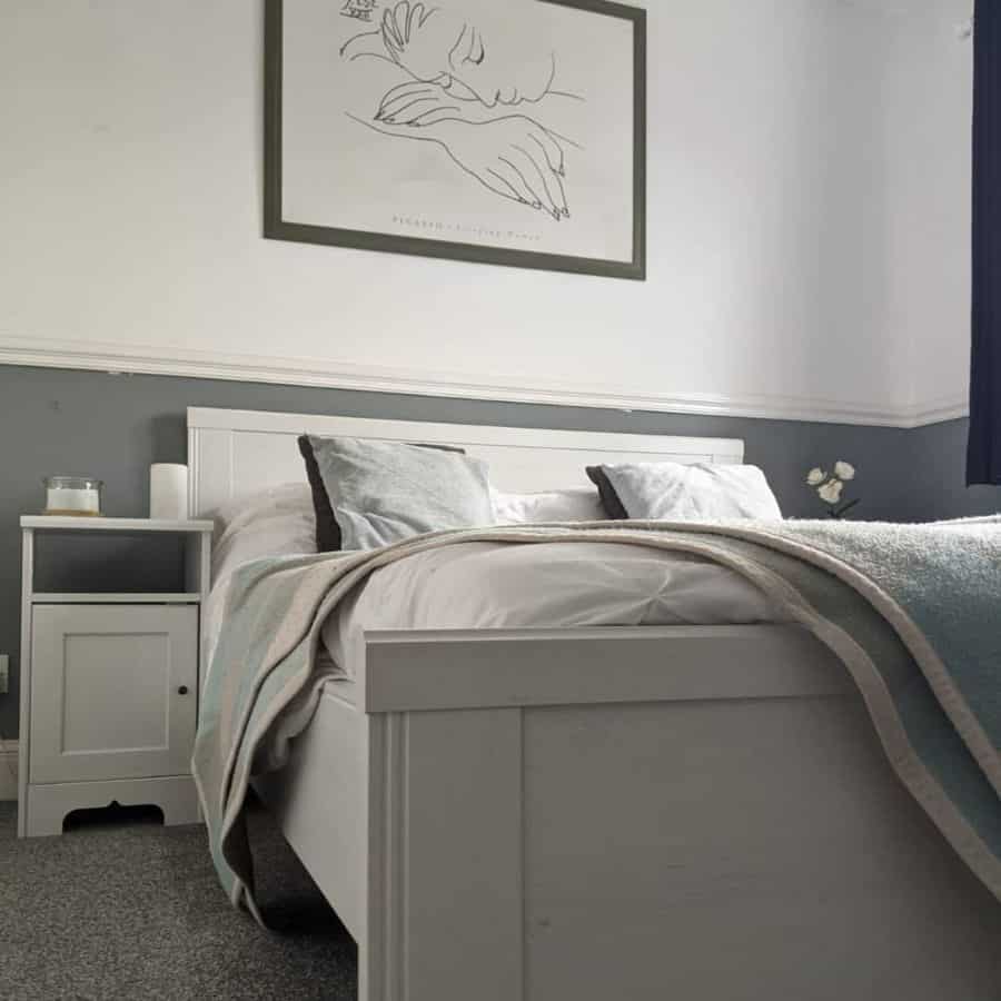 simple spare bedroom with two tone gray and white walls 