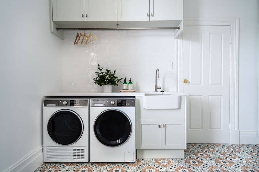 white sink and cabinet laundry room 