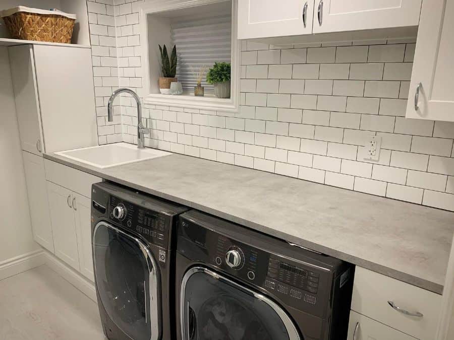 white tile white laundry black washer and dryer