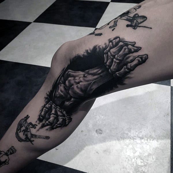 Skeleton Hand Pulling Apart Guys Leg Tattoo