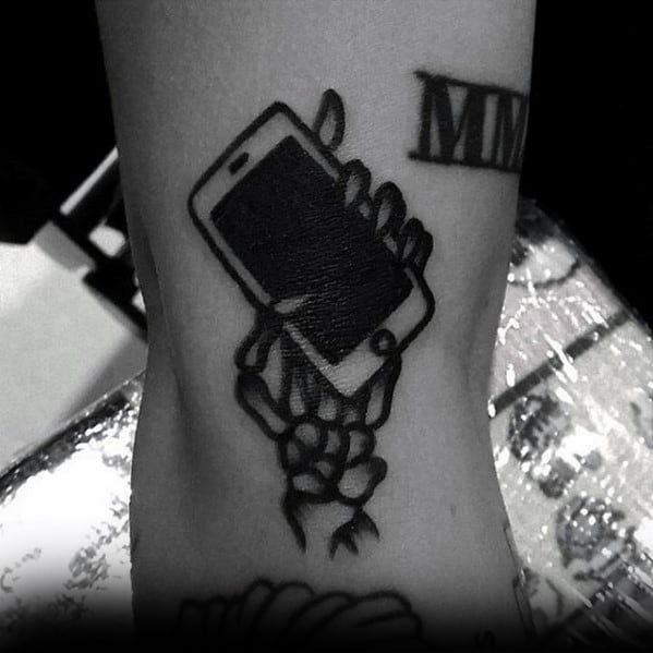 Skeleton Hands With Phone Simple Traditional Mens Arm Tattoo