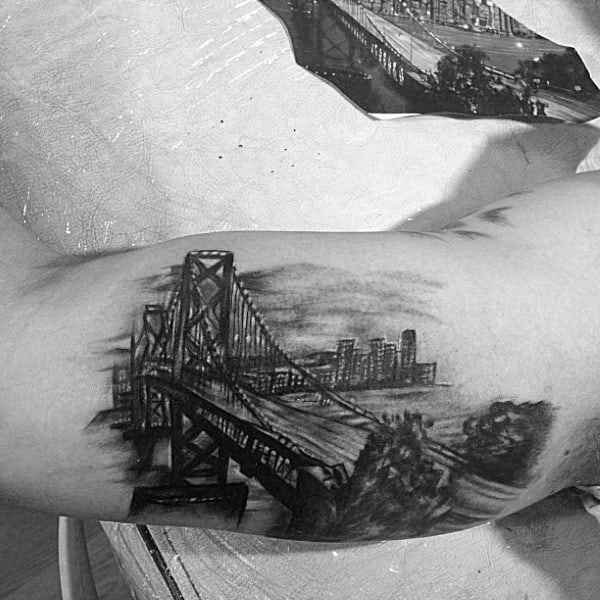 Sketched Black And Grey Shaded Male Golden Gate Bridge Bicep Tattoos