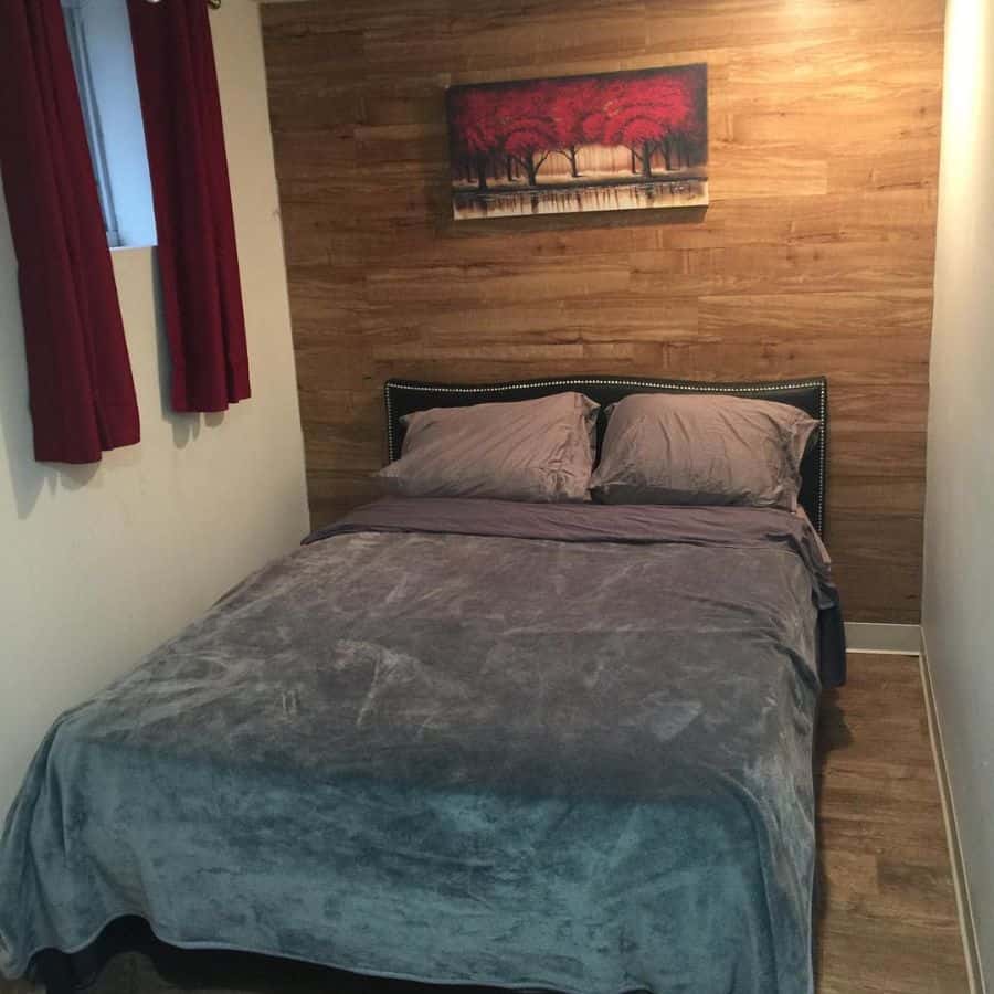 tiny basement bedroom with wood panelling