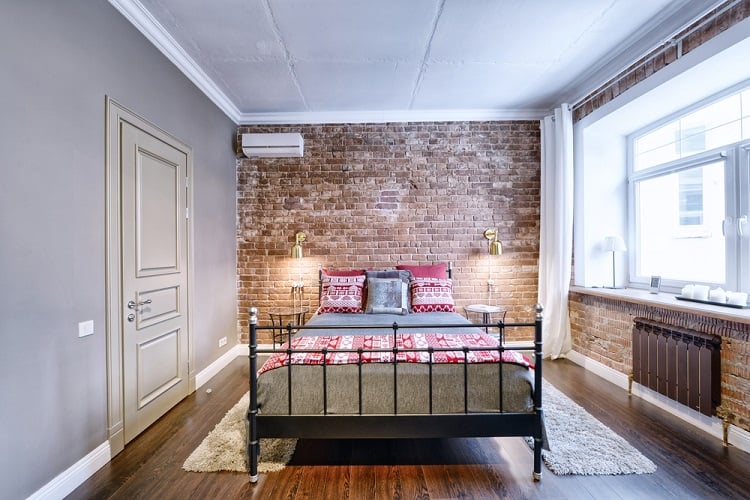 small bedroom exposed brick with unfinished ceiling