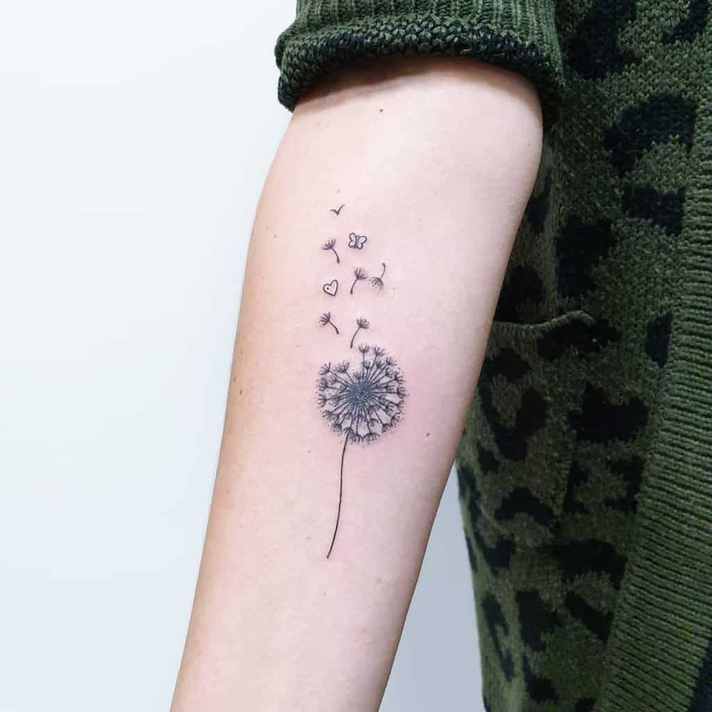 small black dandelion with hearts tattoo