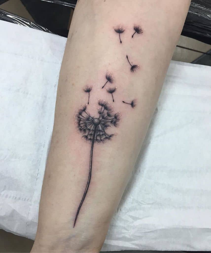 small black dandelion tattoo
