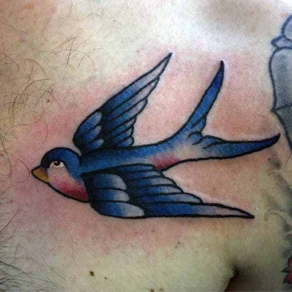 Small Blue Flying Sparrow Bird Traditional Mens Chest Tattoo.