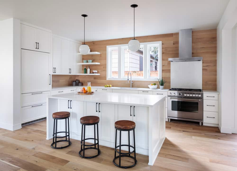 small farmhouse kitchen white cabinets and unit hardwood floors light pendants