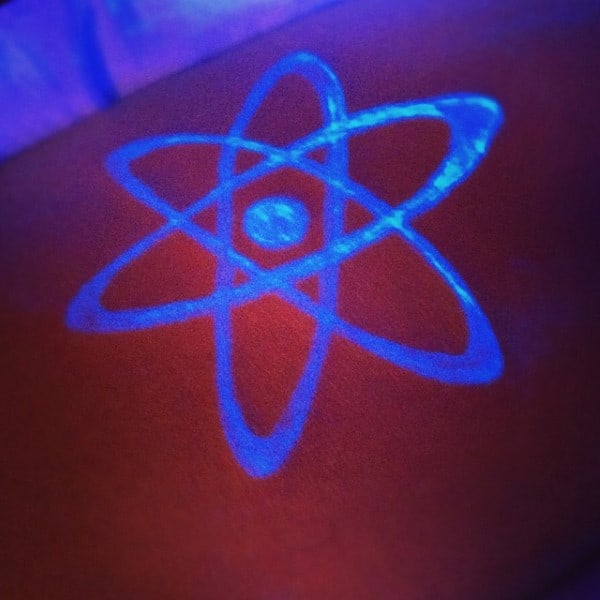 Small Glowing Atom Tattoo With Uv Ink On Arm For Males