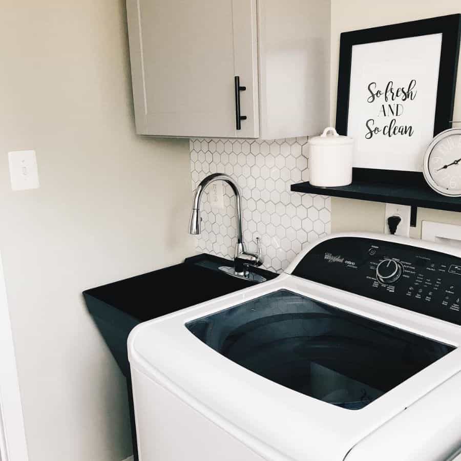 small laundry room black sink and washer