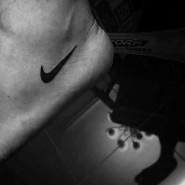 Small Mens Foot Nike Logo Tattoo Design Inspiration