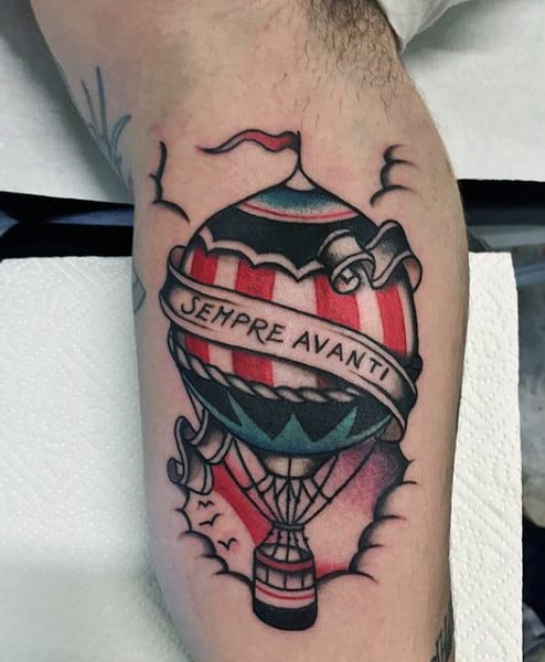 Traditional air balloon tattoo on the left upper arm