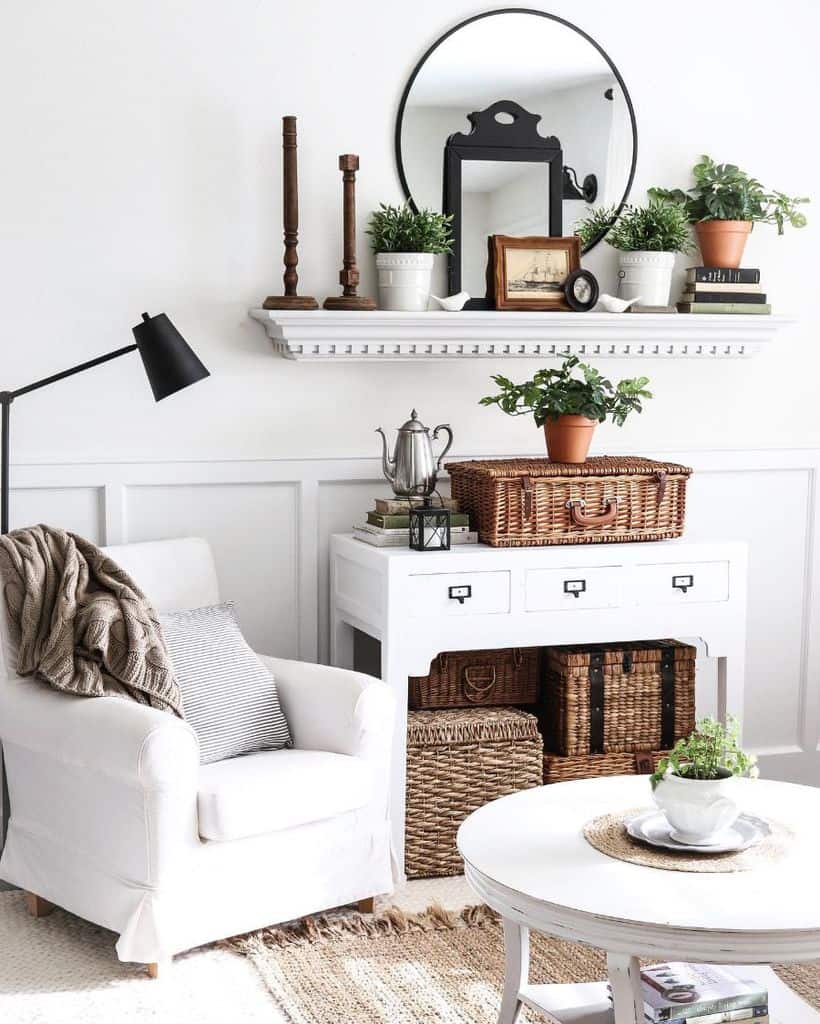 small modern living room white lounge chair white cabinet with wicker basket storage mantle with decorations white coffee table 