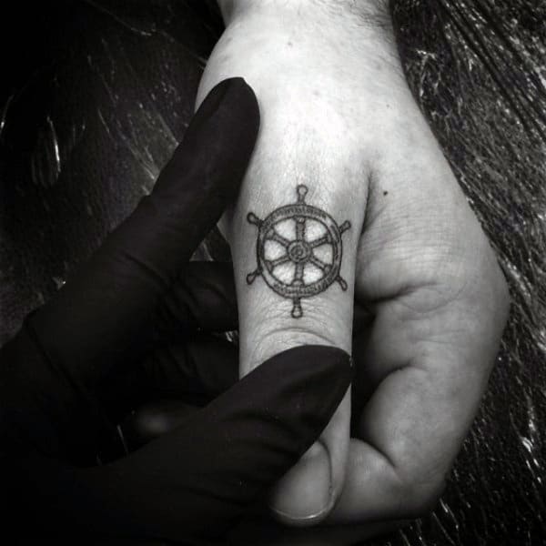Small Ship Wheel Thumb Tattoos For Guys
