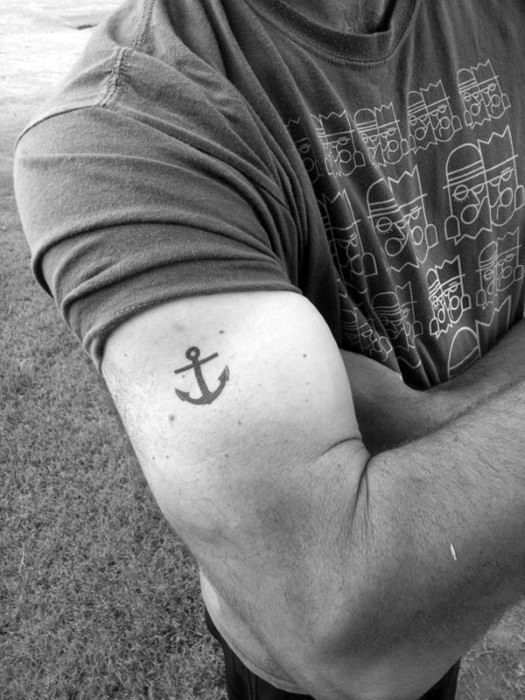 small simple guys black ink anchor tattoo on outer arm