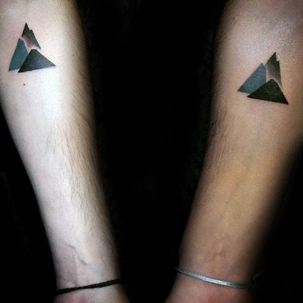 small simple modern matching mountain brother tattoos for guys on inner forearms