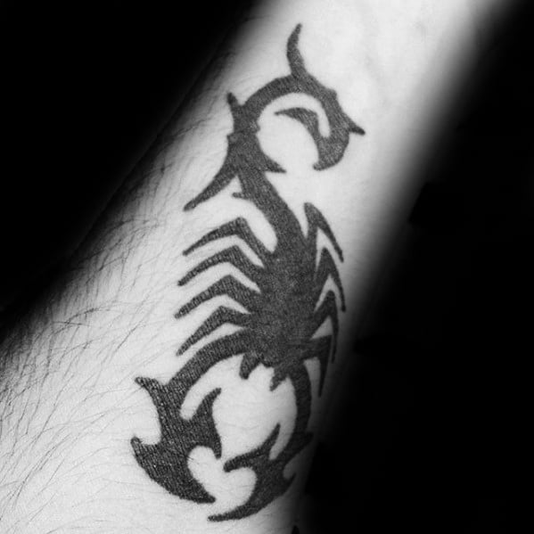 Solid Black Ink Tattoo Of Tribal Scorpion On Mans Inner Forearm