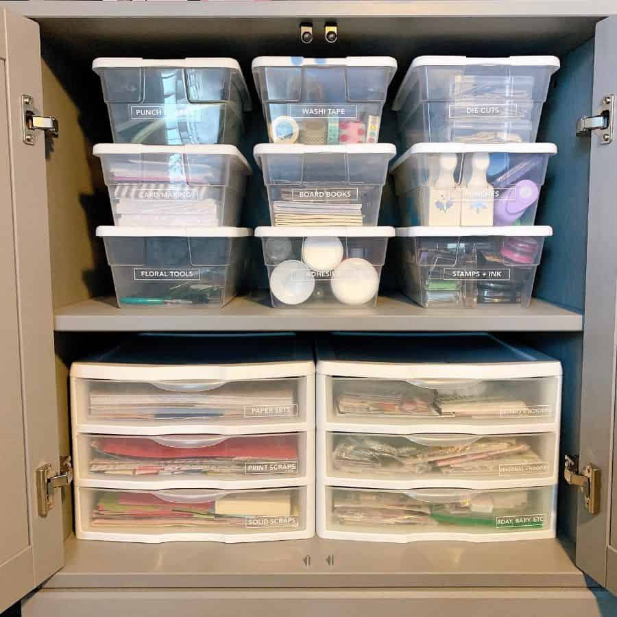 plastic storage boxes in cabinet 