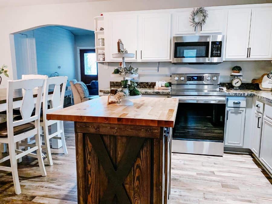 spacious farmhouse kitchen wood island white cabinets 