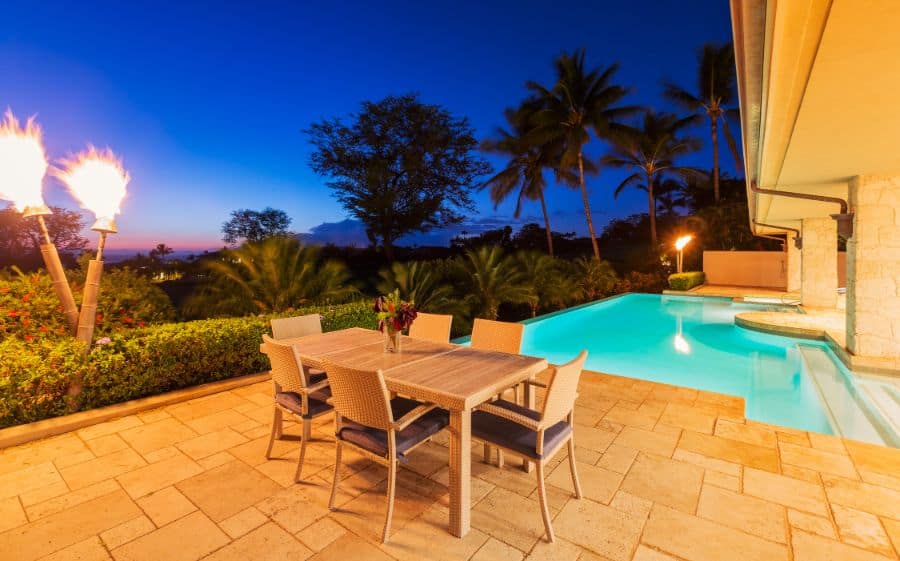 stamped concrete pool deck and dining table and chairs