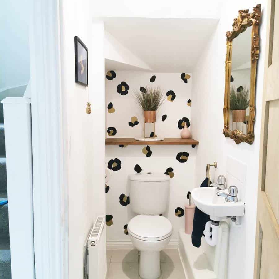 small toilet pattern wallpaper gold framed mirror 