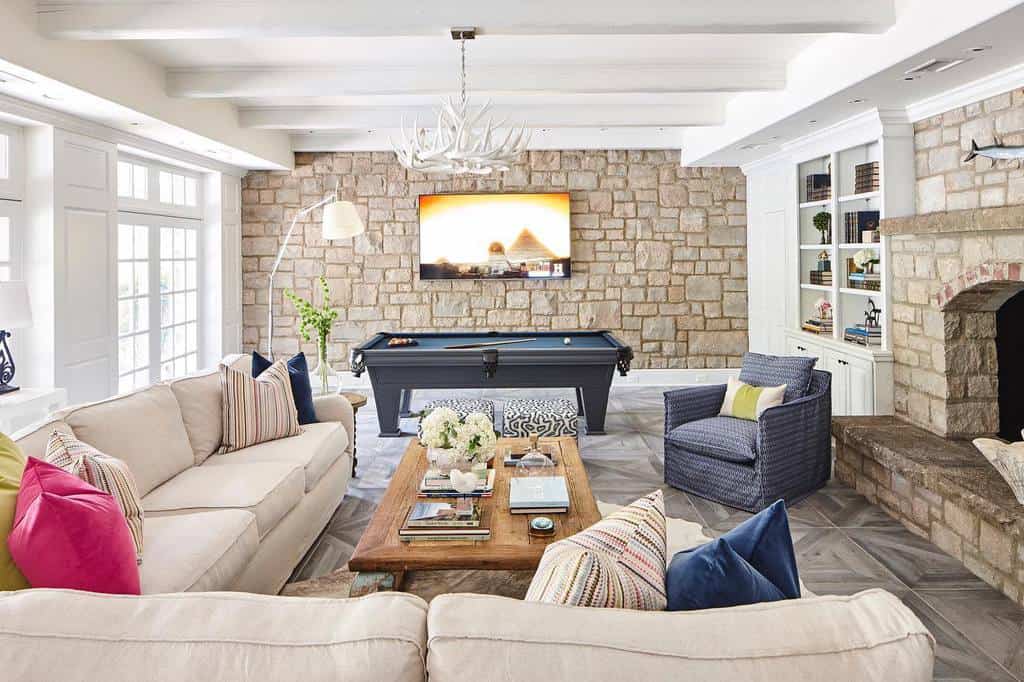 stone wall living room with pool table  