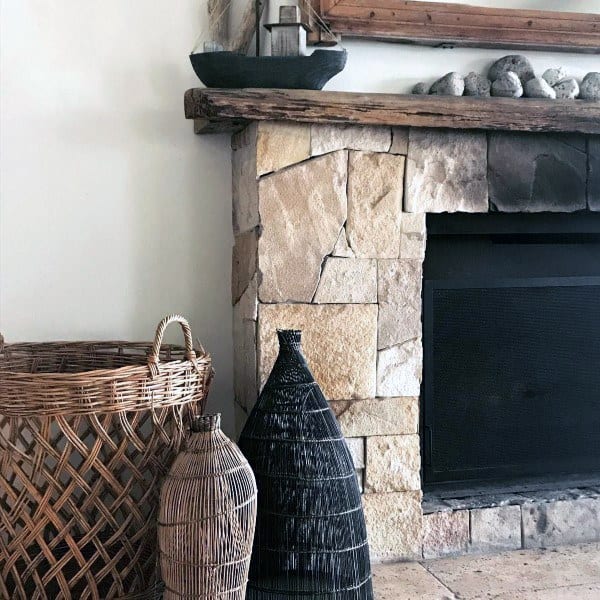 stone fireplace with rustic mantel
