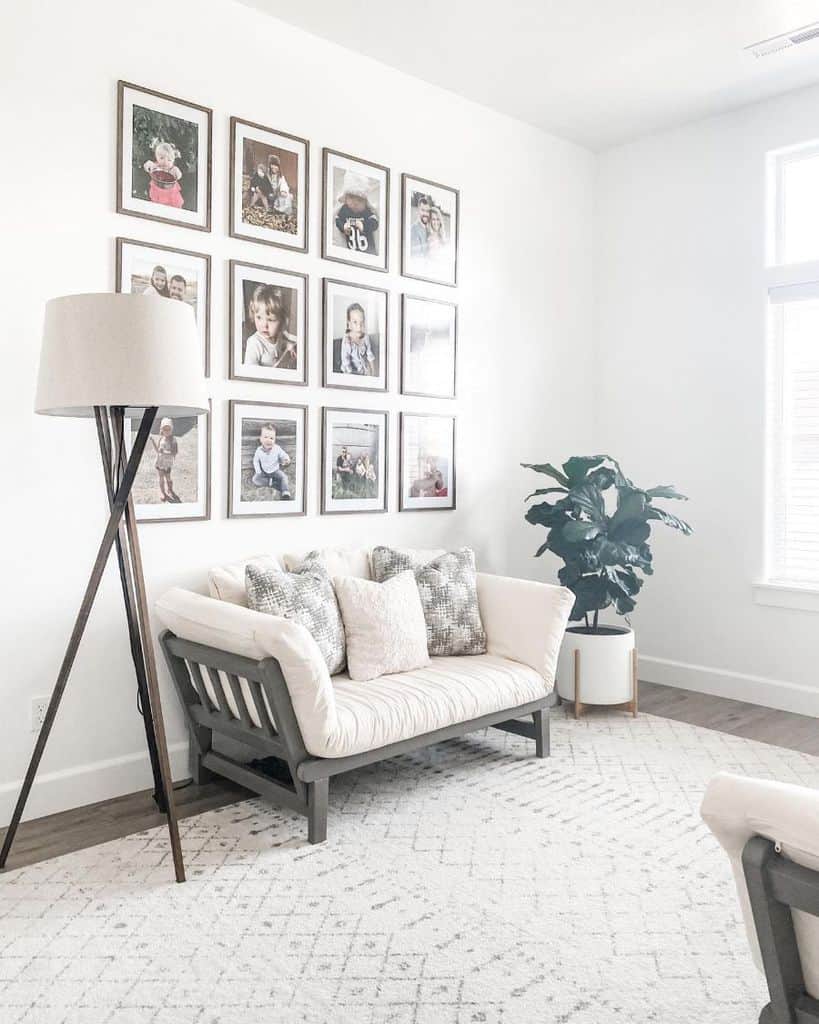 minimalist white living room with framed kids photos on the wall 